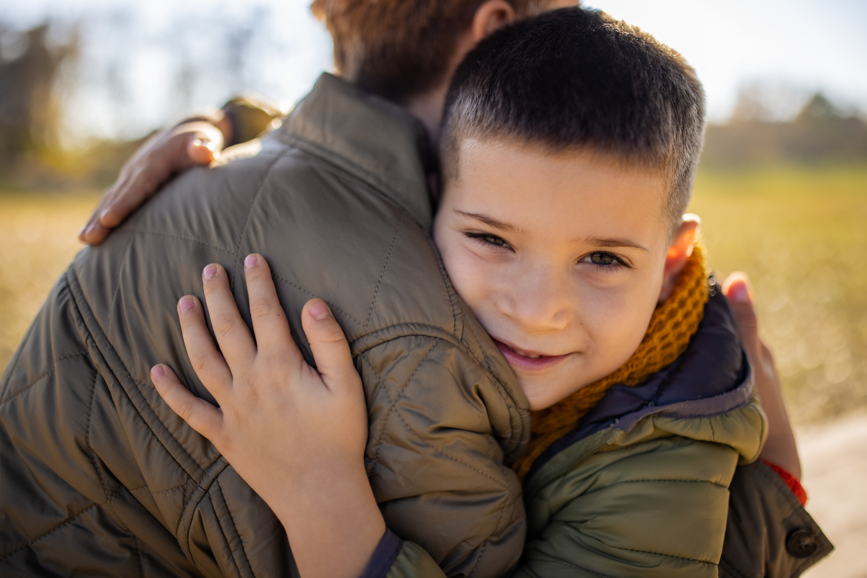 A child hugging their parent, warm and secure