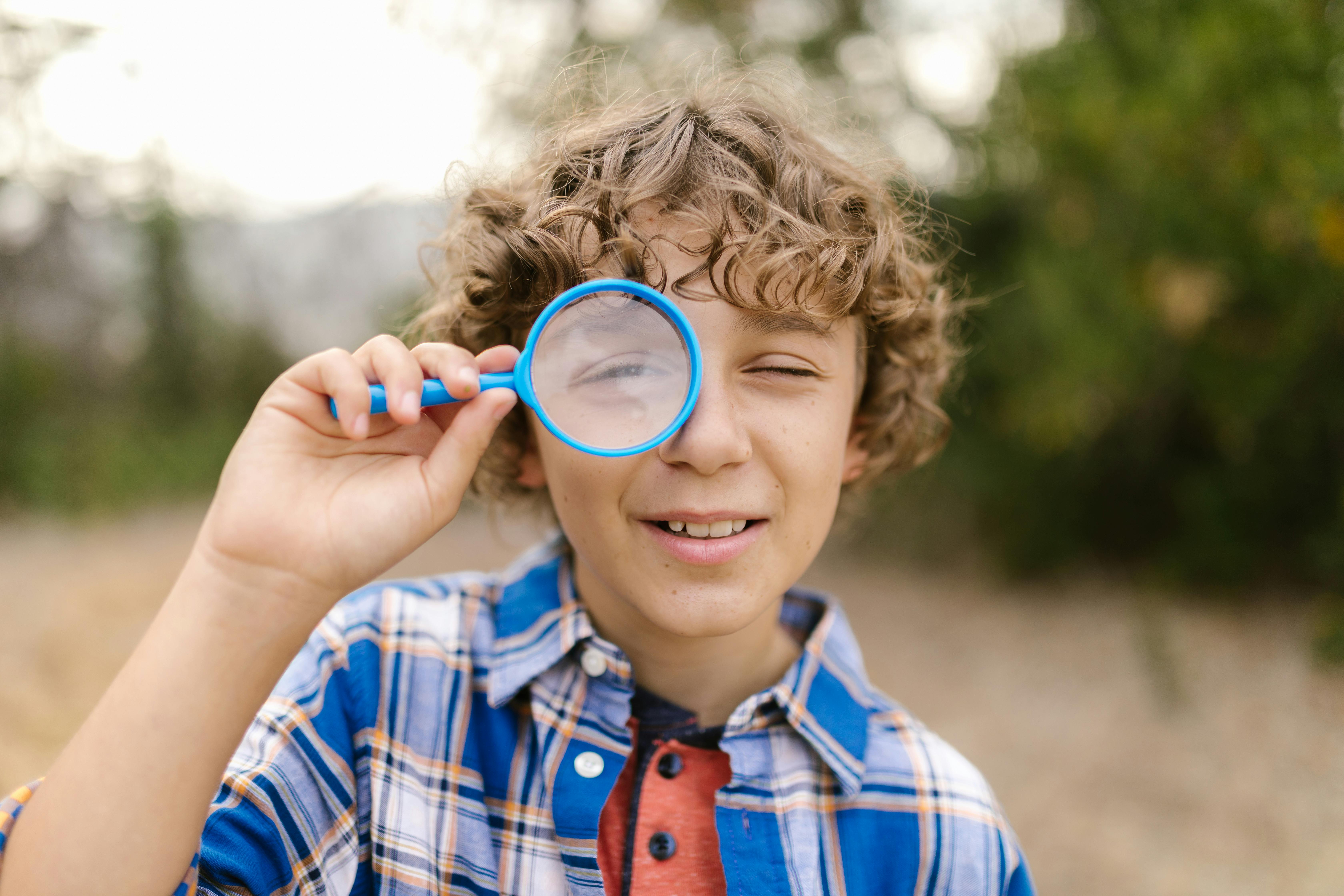 Child with magnifying glass